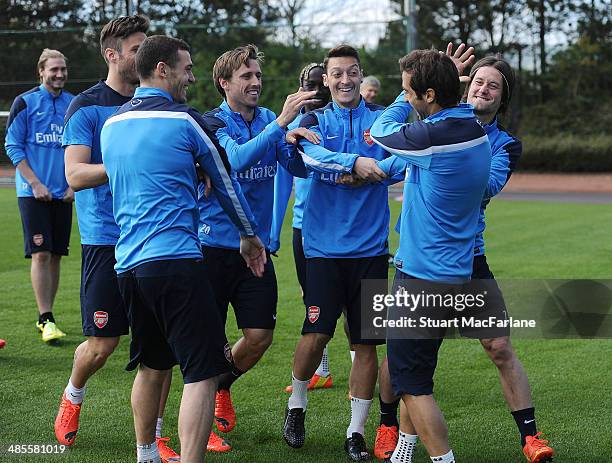 Arsenal's Olivier Giroud, Thomas Vermaelen, Nacho Monreal, Mesut Ozil, Mathieu Flamini and Tomas Rosicky mess around before a training session at...