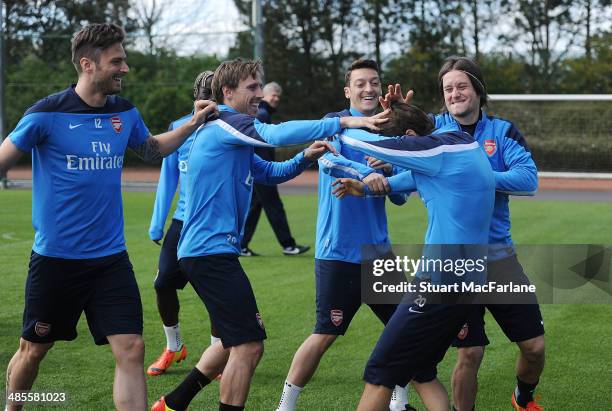 Arsenal's Olivier Giroud, Nacho Monreal, Mesut Ozil, Mathieu Flamini and Tomas Rosicky mess around before a training session at London Colney on...