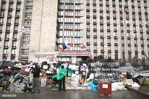 Pro-Russian activists stand guard outside of the Donetsk Regional Administration building on April 19, 2014 in Donetsk, Ukraine. The group of...
