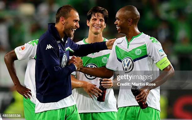 Bas Dost of VfL Wolfsburg celebrates with Timm Klose of VfL Wolfsburg and Naldo of VfL Wolfsburg after winning the Bundesliga match between VfL...