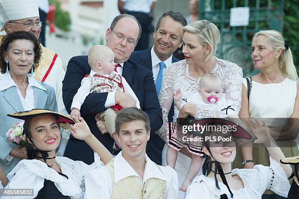 Prince Albert II of Monaco, Prince Jacques, Princess Charlene of Monaco and Princess Gabriella are welcomed by dancers wearing traditional costumes...