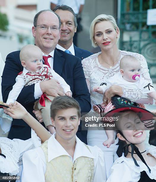 Prince Albert II of Monaco, Prince Jacques, Princess Charlene of Monaco and Princess Gabriella are welcomed by dancers wearing traditional costumes...