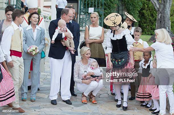 Prince Albert II of Monaco, Prince Jacques, Princess Charlene of Monaco and Princess Gabriella are welcomed by dancers wearing traditional costumes...