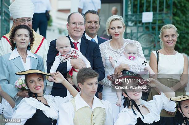 Prince Albert II of Monaco, Prince Jacques, Princess Charlene of Monaco and Princess Gabriella are welcomed by dancers wearing traditional costumes...