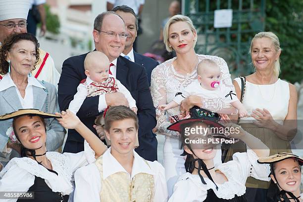 Prince Albert II of Monaco, Prince Jacques, Princess Charlene of Monaco and Princess Gabriella are welcomed by dancers wearing traditional costumes...