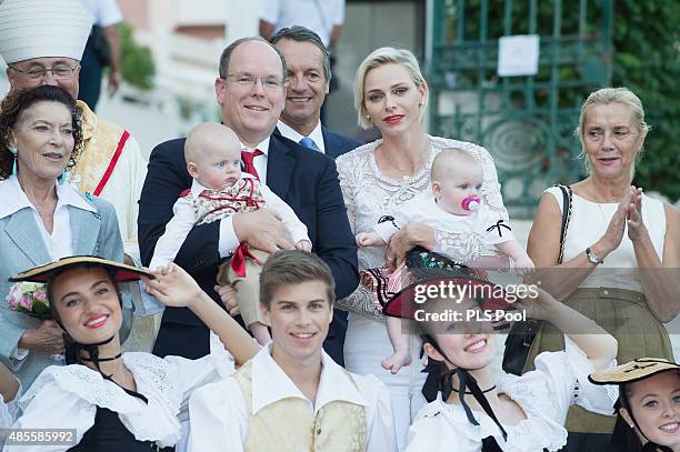 Prince Albert II of Monaco, Prince Jacques, Princess Charlene of Monaco and Princess Gabriella are welcomed by dancers wearing traditional costumes...