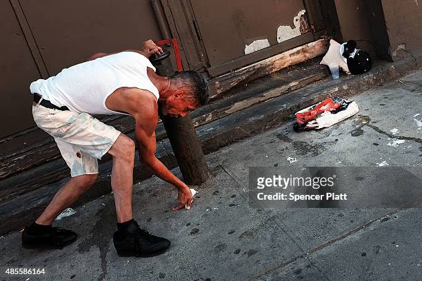 Man pauses while high on K2 or 'Spice', a synthetic marijuana drug, along a street in East Harlem on August 28, 2015 in New York City. New York,...