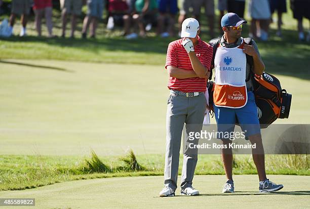 Jordan Spieth of the United States waits on the 12th hole with his caddie Michael Greller during the second round of The Barclays at Plainfield...