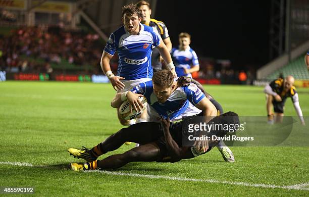Harrison Keddie of Newport Gwent Dragons dives over Christian Wade to score the match winning try in the final against Wasps during the Singha...