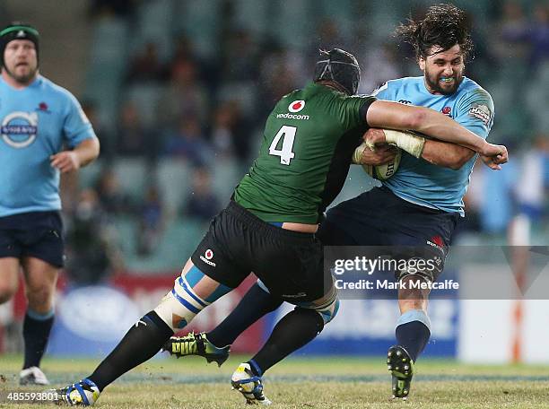 Jacques Potgieter of the Waratahs is tackled by Phillip van der Merwe of the Bulls during the round 10 Super Rugby match between the Waratahs and the...