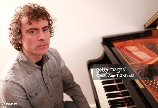 English pianist Paul Lewis poses at his Yamaha piano during a portrait session in his home studio on March 6, 2014 in Bovingdon, United Kingdom.