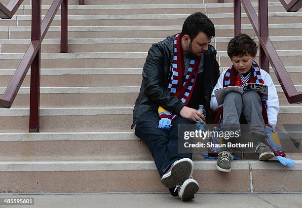 Young Villa fan and his dad read the match day programme before the Premier League match between Aston Villa and Southampton at Villa Park on April...