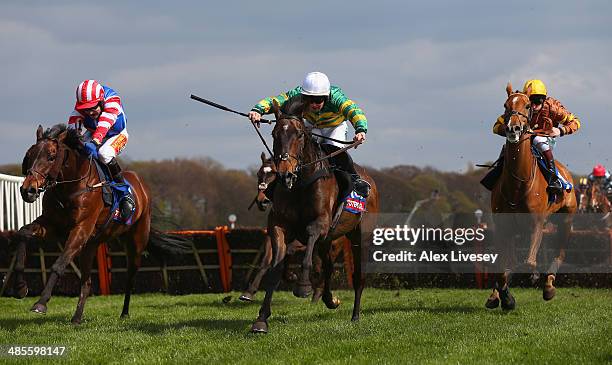 Carlton Jack ridden by Maurice Linehan jumps the last fence ahead of Heath Hunter ridden by Tom Scudamore and Generous Ransom ridden by Jamie Moore...