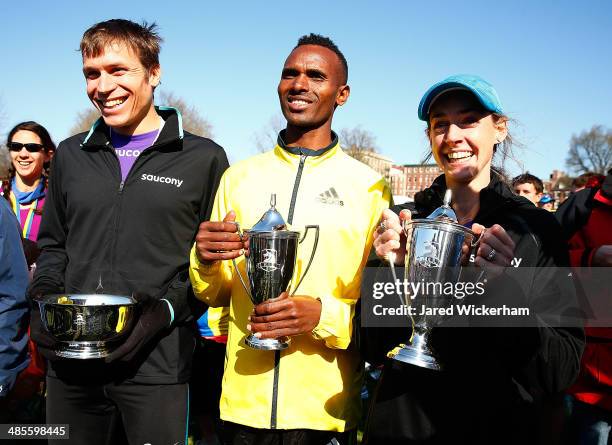 Dejan Gebremeskel of Ethopia , Ben True of the United States , and Molly Huddle of the United States pose for a portrait with their trophies in the...