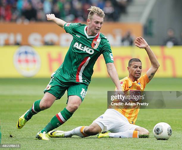 Jan-Ingwer Callsen-Bracker of FC Augsburg ischallenged by Marcel Ndjeng of Hertha during the Bundesliga match between FC Augsburg and Hertha BSC at...