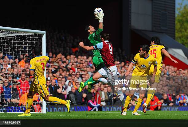 Julian Speroni of Crystal Palace makes a save from Andy Carroll of West Ham during the Barclays Premier League match between West Ham United and...