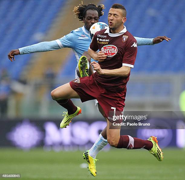 Luis Pedro Cavanda of SS Lazio competes for the ball with Omar El Kaddouri of Torino FC during the Serie A match between SS Lazio and Torino FC at...