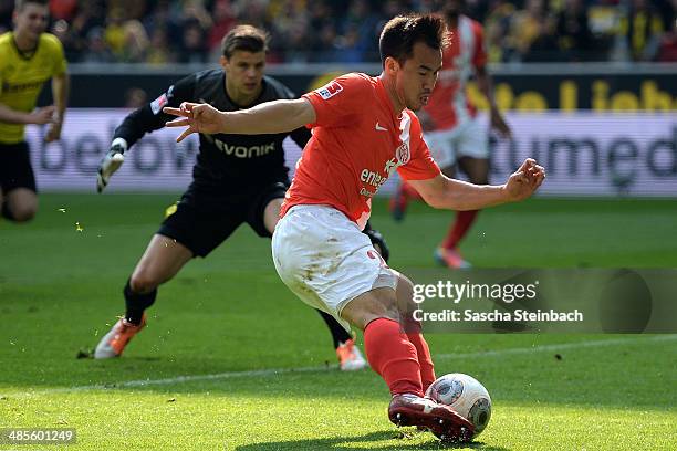 Shinji Okazaki of Mainz scores his team's second goal as goalkeeper Mitchell Langerak of Dortmund looks on during the Bundesliga match between...