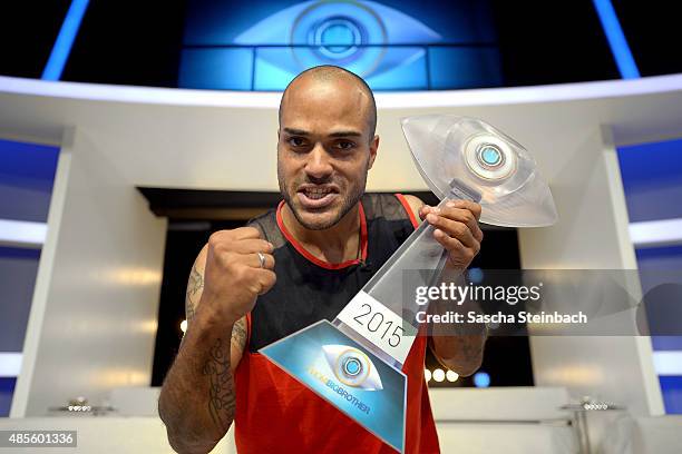 David Odonkor shows the trophy after winning the final show of Promi Big Brother 2015 at MMC studios on August 28, 2015 in Cologne, Germany.