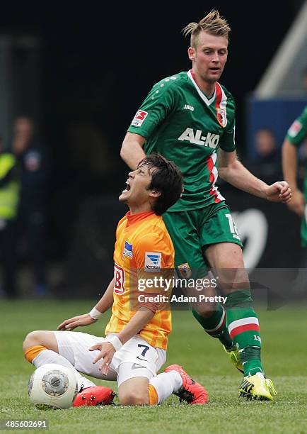 Hajime Hosogai of Hertha screams out in pain during the Bundesliga match between FC Augsburg and Hertha BSC at SGL Arena on April 19, 2014 in...