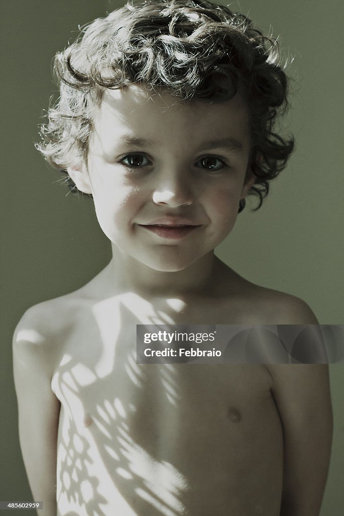 Portrait of child with shadows in chest