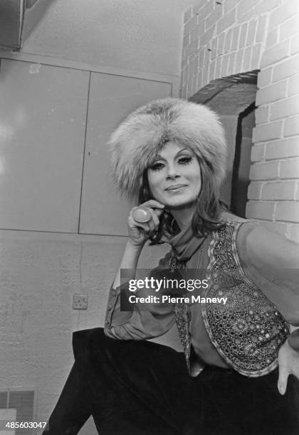 Trans model April Ashley wearing a fur hat and embellished waistcoat, 1st February 1970.