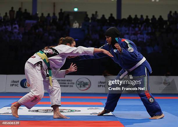 Shefaa Moosa Hassan of United Arab Emirates competes with Amelia Lui of Great Britain in the Women's white belt open weight finals during the Abu...