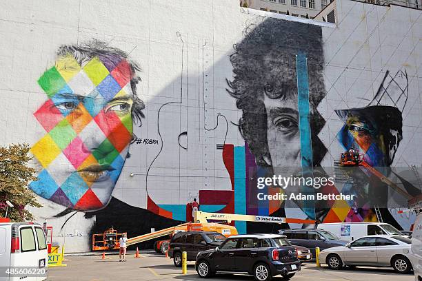 Brazilian artist Eduardo Kobra and his team paint a 60 foot by 150 foot mural of musician Bob Dylan on the side of a building on August 28, 2015 in...