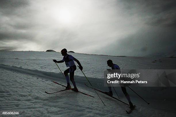 Donny Boake of Canada and William Poffenroth of Canada compete in the FIS Cross-Country Skiing ANC Mass Start Classic Mens race during the Winter...