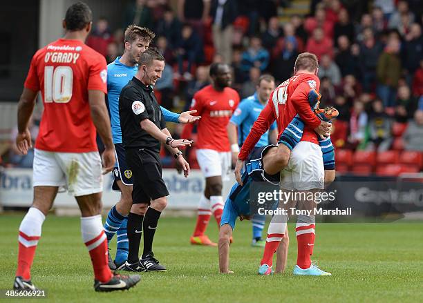 Liam Lawrence of Barnsley tangles with Michael Brown of Leeds United during the Sky Bet Championship match between Barnsley and Leeds United at...