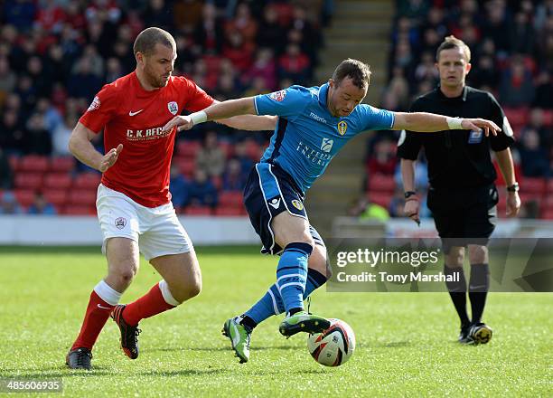 Stephen Dawson of Barnsley tackles Noel Hunt of Leeds United during the Sky Bet Championship match between Barnsley and Leeds United at Oakwell on...
