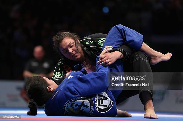 Tanya Araujo of Brazil competes with Ana Carolina Srour of Brazil in the Women's purple belt open weight finals during the Abu Dhabi World...