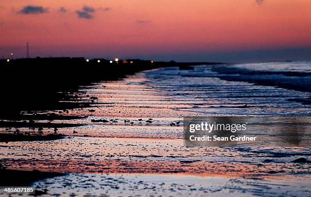 Early morning waves crash along the beach, days after a BP announcement that it is ending its "active cleanup" on the Louisiana coast from the...