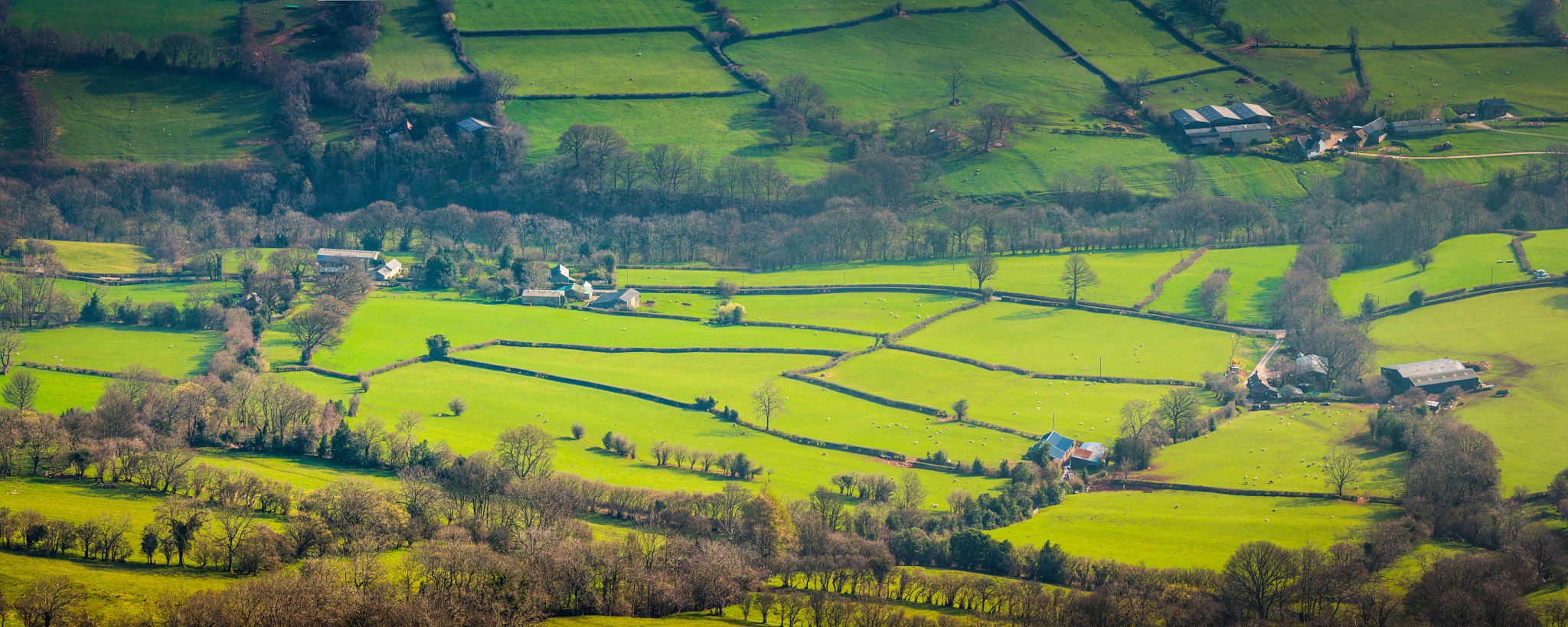 Green fields patchwork pasture mountain valley hill farms agriculture panorama Green fields patchwork pasture mountain valley hill farms agriculture panorama