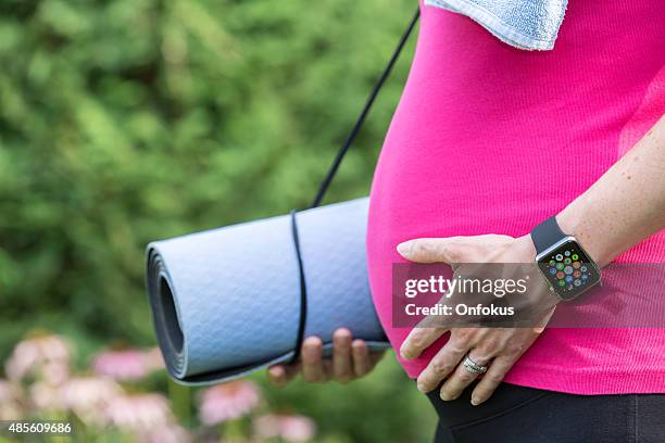 pregnant woman wearing and using apple watch - apple watch heart stock pictures, royalty-free photos & images