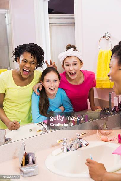 three girls at sleepover looking into mirror in bathroom - caucasian 11 12 girl portrait vertical beautiful stock pictures, royalty-free photos & images