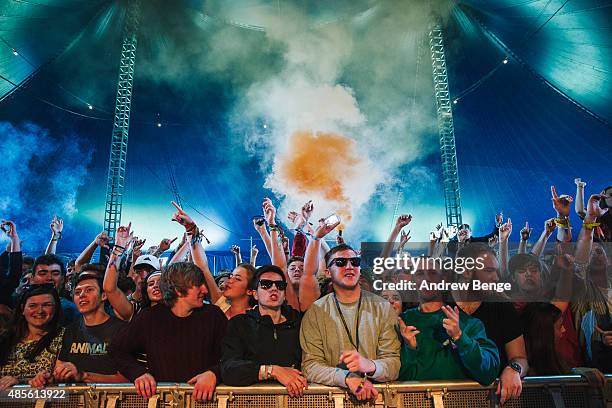 Festival goers let of a flare whilst The Sherlocks perform on the Festival Republic stage at Leeds Festival at Bramham Park on August 28, 2015 in...