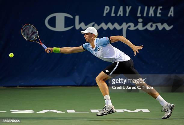 Kevin Anderson of South Africa returns a shot from Malek Jaziri of Tunisia during the fifth day of the Winston-Salem Open at Wake Forest University...