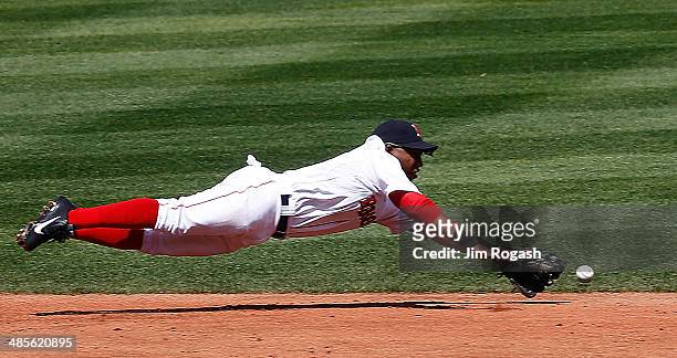 Jonathan Herrera of the Boston Red Sox is unable to field a ball hit by Nelson Cruz of the Baltimore Orioles in the first inning at Fenway Park on...