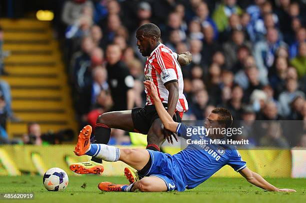 Cesar Azpilicueta of Chelsea fouls Jozy Altidore of Sunderland to concede a penalty during the Barclays Premier League match between Chelsea and...