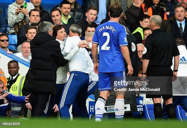 Chelsea coach Rui Faria is held back by Jose Mourinho and other members of coaching staff as he confronts match referee Mike Dean during the Barclays...