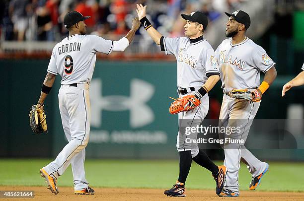 Ichiro Suzuki of the Miami Marlins celebrates with Dee Gordon after a 4-3 victory against the Washington Nationals at Nationals Park on August 28,...