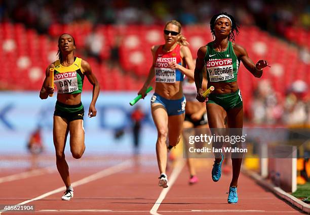 Christine Day of Jamaica, Kseniya Aksyonova of Russia and Patience Okon George of Nigeria compete in the Women's 4x400 Metres Relay heats during day...