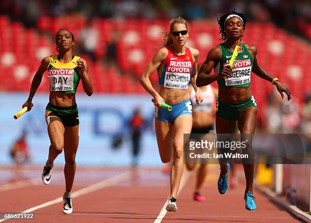 Christine Day of Jamaica, Kseniya Aksyonova of Russia and Patience Okon George of Nigeria compete in the Women's 4x400 Metres Relay heats during day...