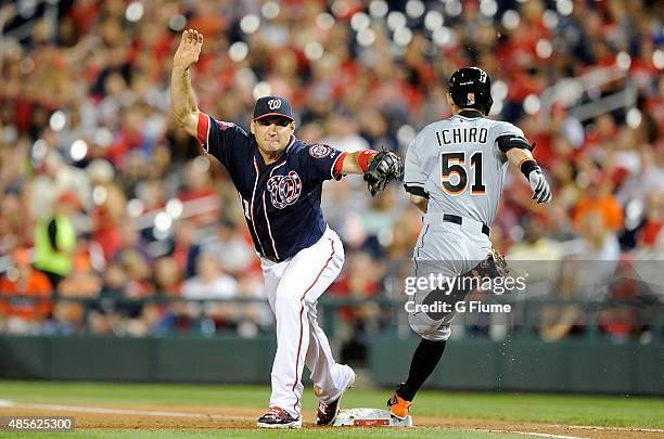 Ryan Zimmerman of the Washington Nationals forces out Ichiro Suzuki of the Miami Marlins at first base in the fifth inning at Nationals Park on...