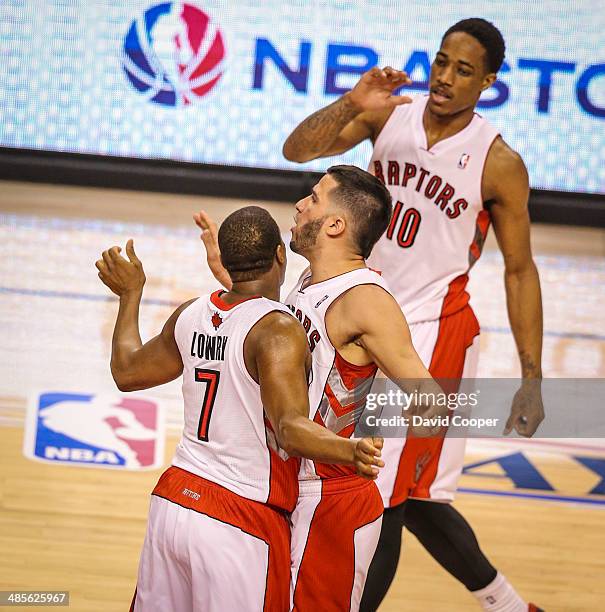 Toronto Raptors guard Kyle Lowry and guard Greivis Vasquez bump chests after Lowry made a 3 at the buzzer to end the third quarter 62-67 during the...