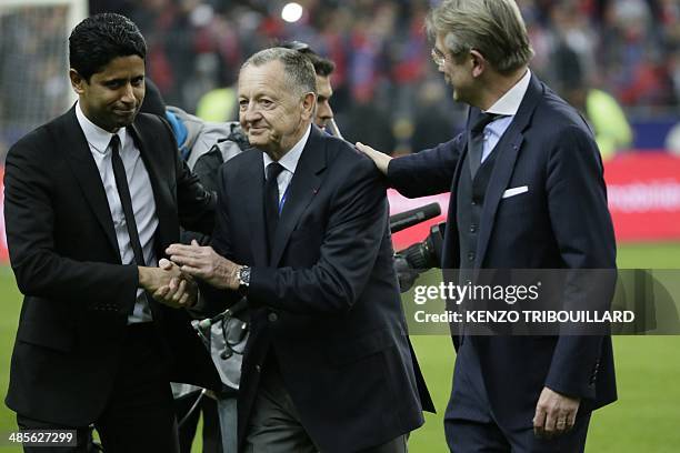 Paris Saint-Germain's Qatari president Nasser al-Kahlaifi shakes hands with Lyon's French president Jean-Michel Aulas next to French Ligue de...
