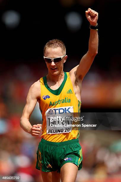 Jared Tallent of Australia celebrates after crossing the finish line to win silver in the Men's 50km Race Walk final during day eight of the 15th...