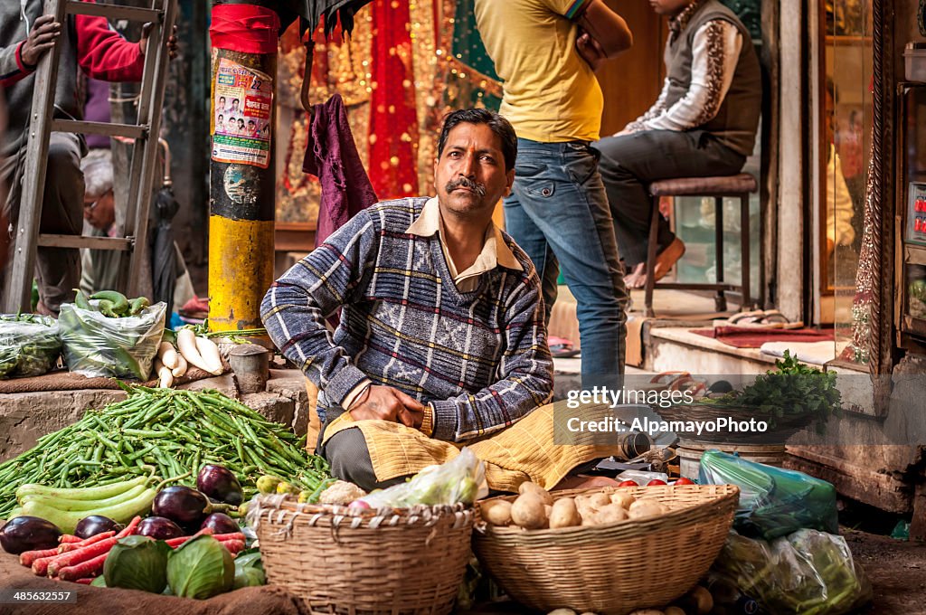 Man selling vegetables at the Old Delhi spice market