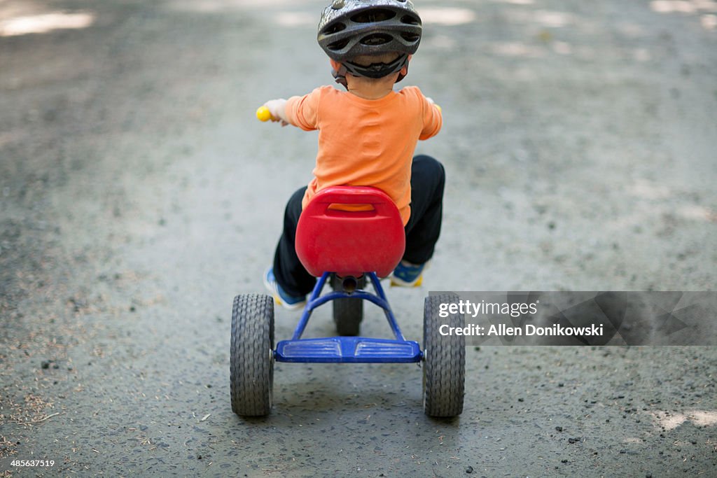 Child on the move on his tricycle